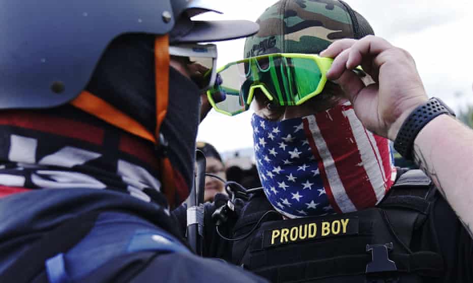A member of the Proud Boys, right, stands in front of a counter-protester as right-wing demonstrators rally on Saturday in Portland, Oregon.