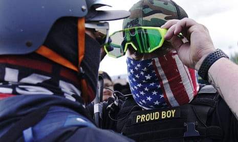 A member of the Proud Boys, right, stands in front of a counter-protester as right-wing demonstrators rally on Saturday in Portland, Oregon.