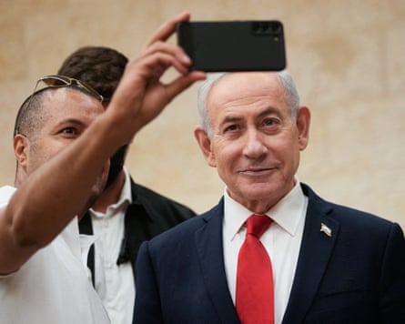 Benjamin Netanyahu poses for a selfie with a supporter
