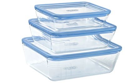 A stack of three glass Pyrex food storage containers