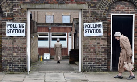 Two women enter a polling station to vote in the EU referendum in London.
