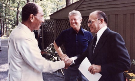 President Anwar Sadat of Egypt, left, shaking hands with Israeli Prime Minister Menachem Begin of Israel, with Jimmy Carter looking on at the US presidential retreat at Camp David, Maryland, in 1978, before the announcement of the historic peace accords the following year.