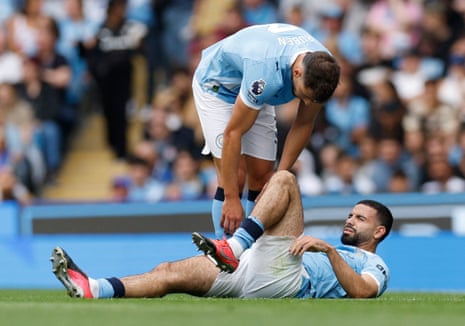 Manchester City's Ruben Dias checks on Rayan Ait-Nouri, who looks to be in a bit of discomfort.
