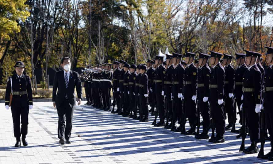 Fumio Kishida inspects an honour guard at Camp Asaka.