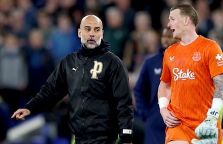 Pep Guardiola talks to Everton goalkeeper Jordan Pickford
