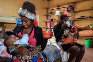 Mothers breast feed their babies in their dormitory during a tea break
