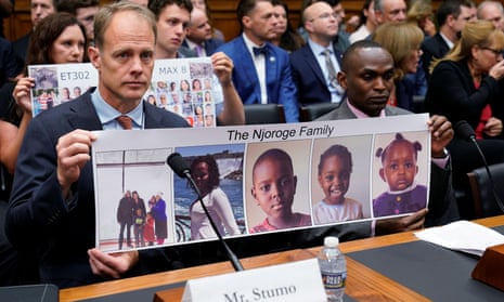 Michael Stumo and Paul Njoroge, right, hold a photo of Njoroge’s family members during a congressional hearing in Washington DC.