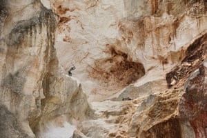 A worker pounds rock to make gravel and sand in Kenscoff, a neighbourhood of Port-au-Prince