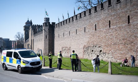 Police move on a group of three people from Cardiff Castle on 26 March.