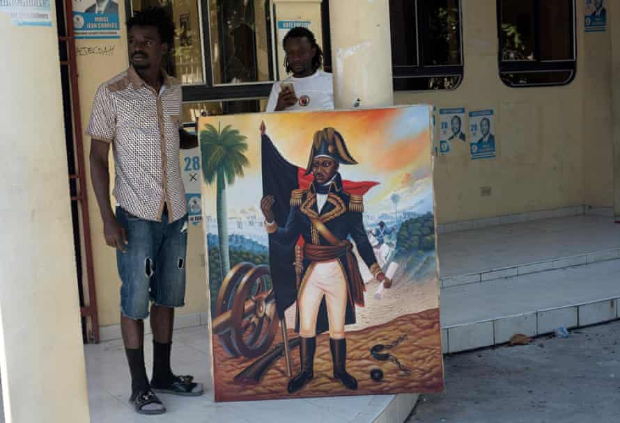 Activists with a portrait of Dessalines.