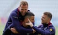 Harry Kane, Kyle Walker with Kieran Trippier smile during an England training session