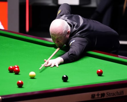 John Higgins plays a shot.
