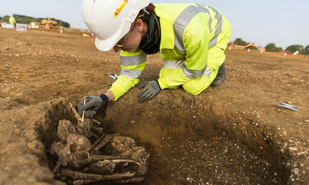 An archaeologist excavates a skeleton in Cambridgeshire.