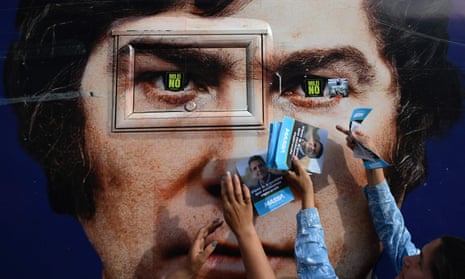 Supporters of Sergio Massa hold posters of their candidate in front of an image of Milei in Ezeiza, Buenos Aires province.