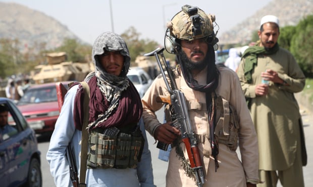 Taliban fighters stand guard in Kabul