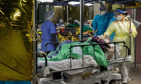 Medical staff move a Covid patient indoor at a hospital in Hong Kong.
