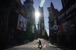 A pedestrian makes his way across a lightly trafficked intersection in Times Square, New York