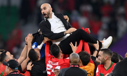 The Morocco manager, Walid Regragui, is lifted aloft after his side's quarter-final victory against Portugal