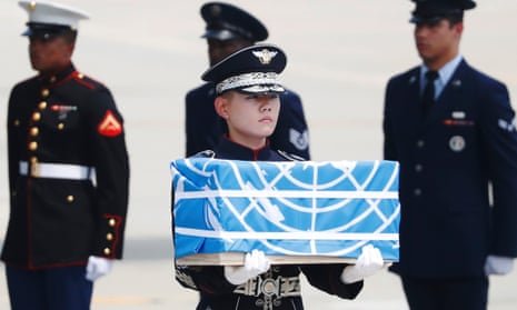 A soldier carries a casket containing the remains of a US soldier killed in the Korean war during a ceremony at Osan air base, South Korea. 