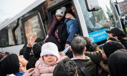 Syrian refugees board a bus as they head to the border villages of Edirne province from Istanbul.