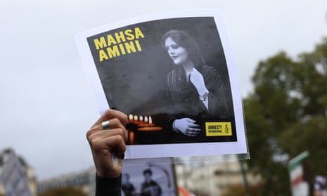 A portrait of Mahsa Amini held aloft during a demonstration in Paris in October in support of Iranians protesting against her death in police custody.
