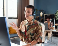 Young woman talking into a headset in an office