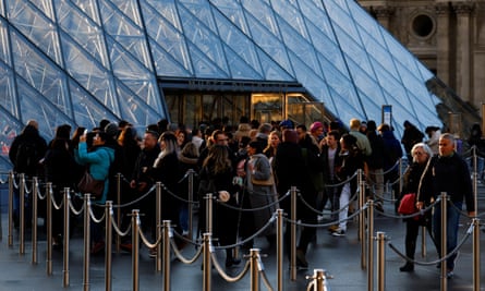 A queue forming outside the Louvre’s glass pyramid