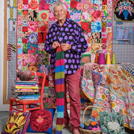 The designer in his upstairs studio. Behind him is a flannel wall hanging, where he lays out his quilts