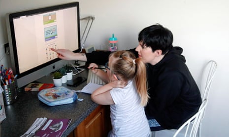 Charlotte Rose assists one of her children, who is home schooled in Milton Keynes, Britain, January 5, 2021. 