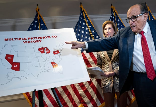 Rudy Giuliani points to a map as he speaks to the press about various lawsuits aimed at overturning the 2020 election. Also pictured is Trump attorney Sidney Powell.