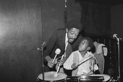 Panther Bobby Seale and his son Malik Nkrumahy Stagolee, 6, relax by playing drums here, after a political campaign in which Seale challenged the incumbent mayor in California’s 5th largest city.