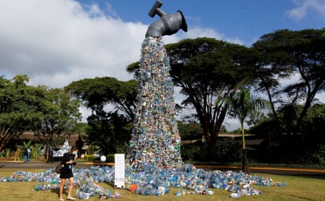 A delegate in Kenya looks at a 10-metre-high art installation of plastic waste urging people to ‘turn off the plastic tap’.