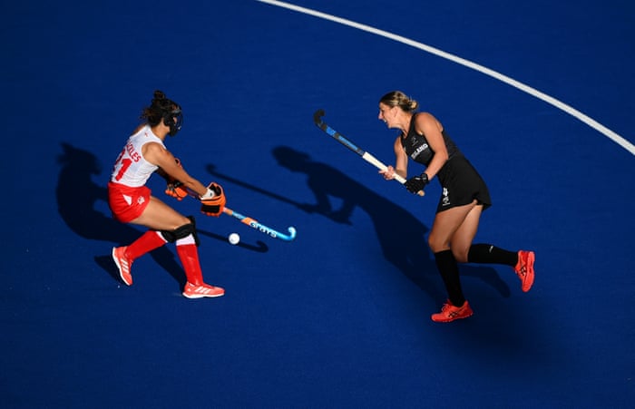 Olivia Merry of New Zealand shoots whilst under pressure from England’s Fiona Crackles.