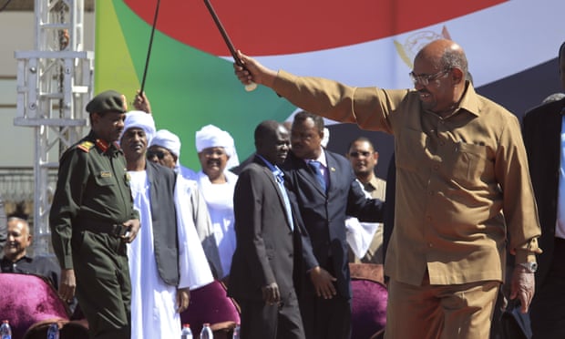 Omar al-Bashir greets supporters at a rally in Khartoum