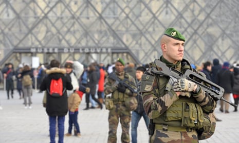 French military officers stand guard before the New Year’s Eve celebrations at the Louvre.