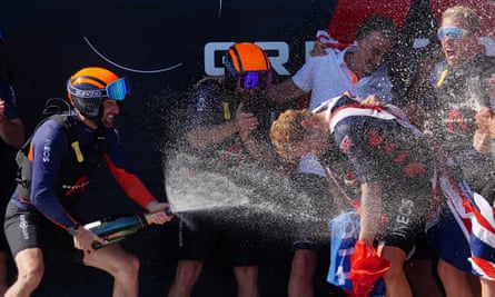 Britannia’s co-skipper and helmsman Ben Ainslie (L) celebrates with the rest of the crew after winning the Louis Vuitton Cup