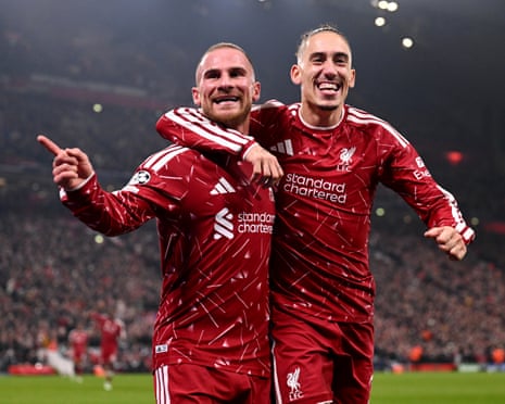 Alexis Mac Allister and Kostas Tsimikas embrace, celebrating a Liverpool goal