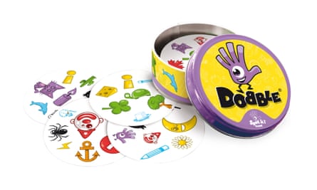 An open tin of the Dobble game with the cards around it