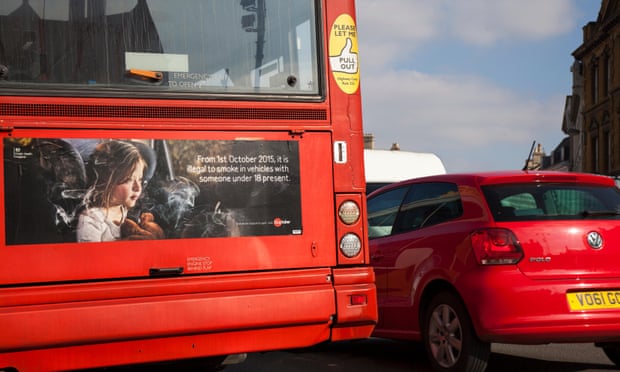 Red bus showing ad for smoking ban