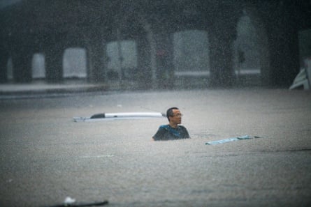 People swim in floodwater in Zhengzhou