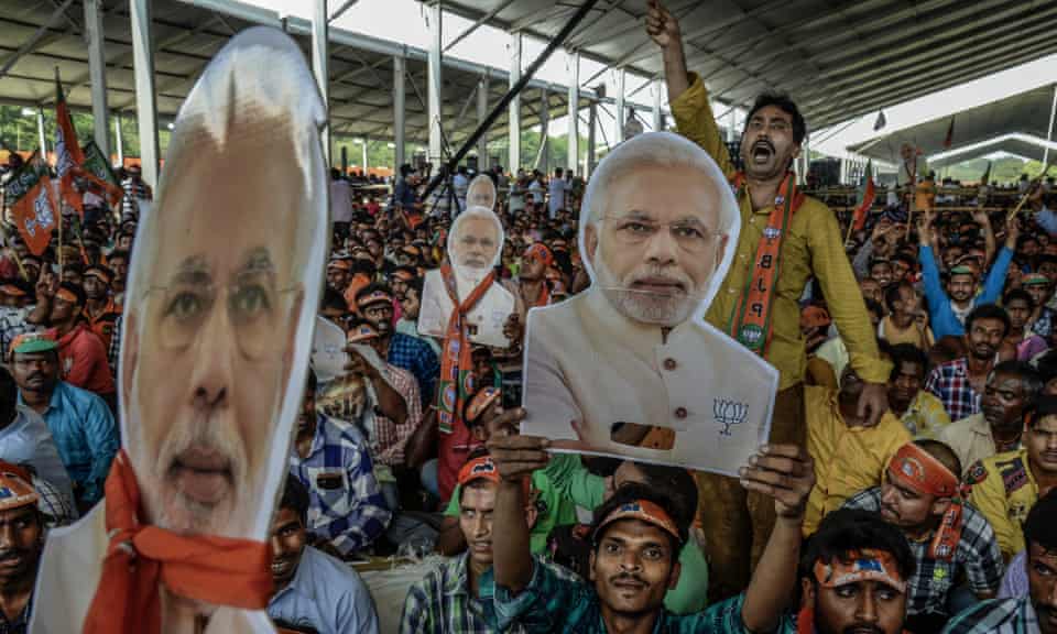 Supporters wave cut-outs of India’s prime minister, Narendra Modi, as the ‘gargantuan’ election begins. 