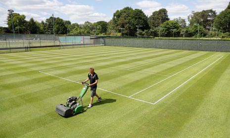 Head groundsman Paul Bishop cuts the grass on the courts at St George’s Hill Lawn Tennis Club in Weybridge as they prepare to reopen.