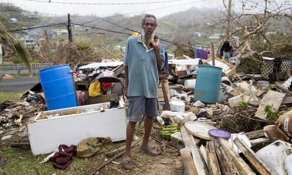 An 80-year-old man stands in front of his destroyed home in Marigot, Dominica, on 27 September. 