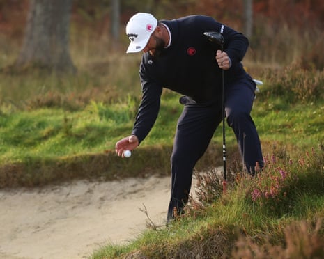 Jon Rahm takes a drop in a bunker