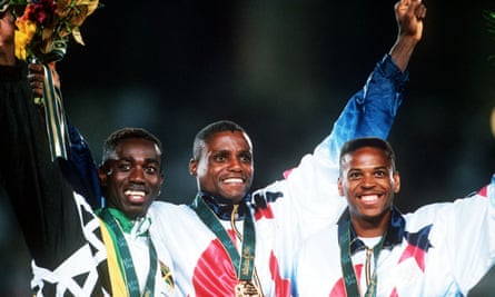 Carl Lewis (centre) celebrates on the podium in 1996