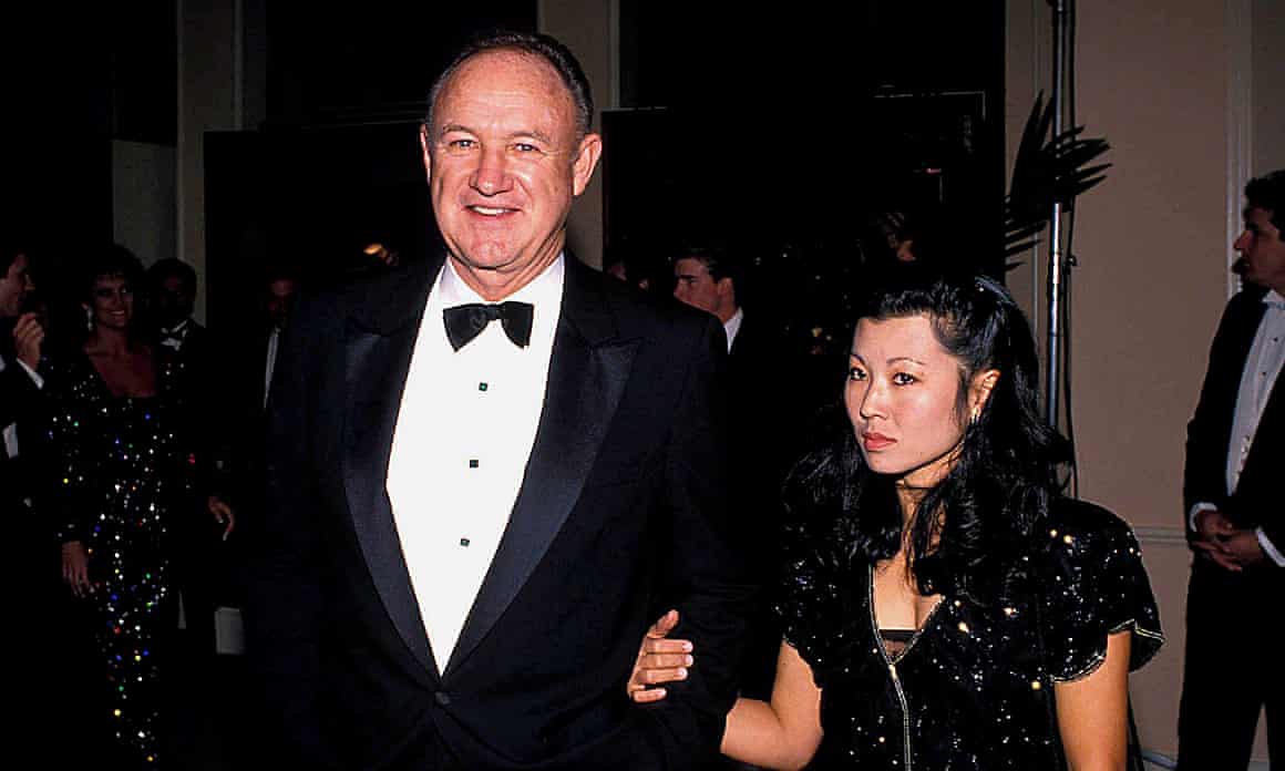 Gene Hackman in black tie and Betsy Arakawa in a black dress