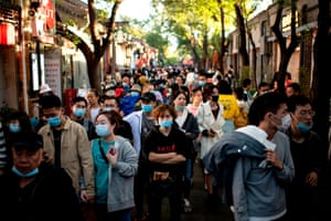 People walk past shops during the national “golden week” holiday in Beijing on Monday.