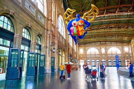 A colourful angel floats over the concourse at Zurich Hauptbahnhof.