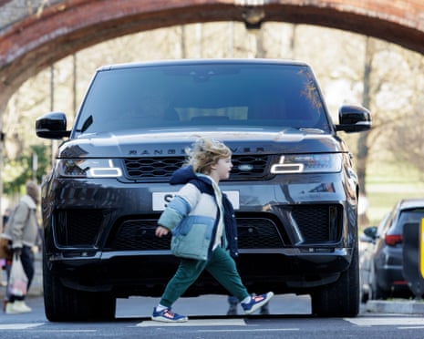 Young child in front of SUV