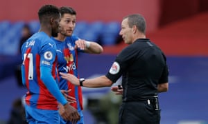 Referee Kevin Friend explains his decision after awarding a penalty for Joel Ward’s handball.